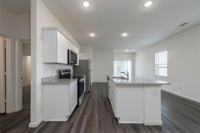 6303 Tropicana Ln, Forney, TX 75126 - kitchen with stainless steel appliances, dark wood-style flooring, white cabinets, a sink, and light stone countertops