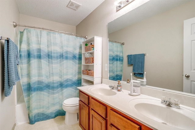 10053 Pronghorn Ln, Fort Worth, TX 76108 - full bath with double vanity, toilet, a textured ceiling, and tile patterned flooring