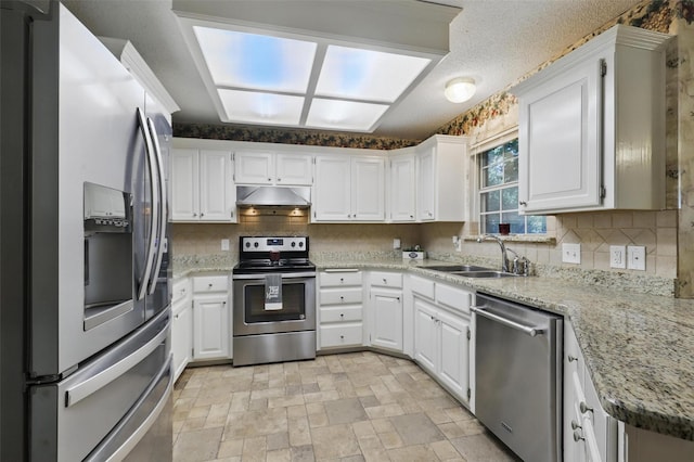 221 Valley Ranch Rd, Weatherford, TX 76087 - kitchen featuring stainless steel appliances, tasteful backsplash, under cabinet range hood, and white cabinetry