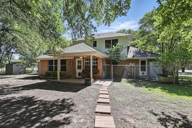 221 Valley Ranch Rd, Weatherford, TX 76087 - view of front of property with a storage unit, a patio, and brick siding