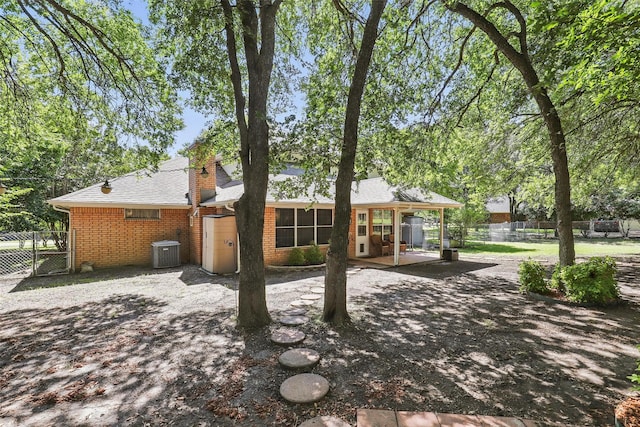 221 Valley Ranch Rd, Weatherford, TX 76087 - rear view of property with a patio, brick siding, a chimney, and roof with shingles