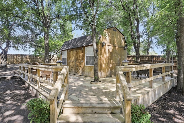 221 Valley Ranch Rd, Weatherford, TX 76087 - wooden terrace featuring a fenced backyard, outdoor dining area, and a storage shed