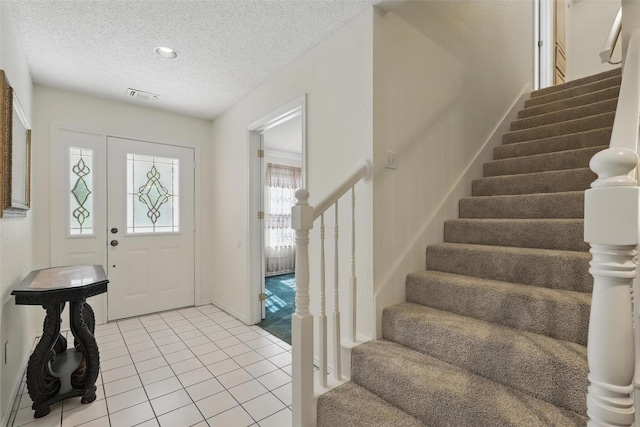 221 Valley Ranch Rd, Weatherford, TX 76087 - foyer entrance with stairway, a textured ceiling, and light tile patterned floors