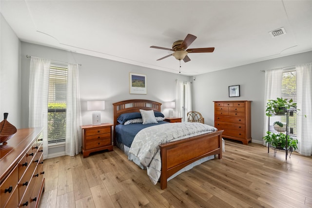 bedroom with light wood finished floors and a ceiling fan
