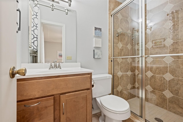 full bathroom featuring a shower stall, vanity, and toilet