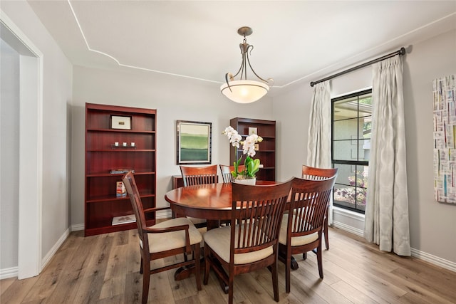 dining area featuring wood finished floors and baseboards