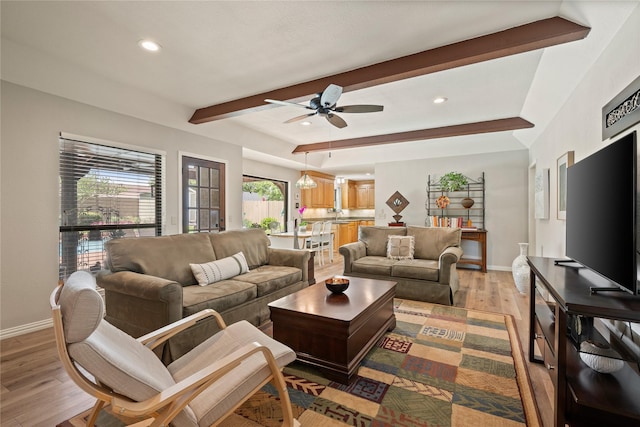 living area with beamed ceiling, baseboards, a ceiling fan, light wood finished floors, and recessed lighting