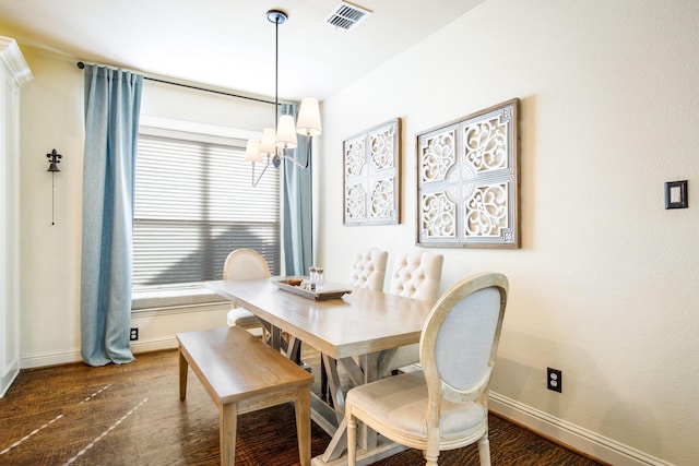 dining room featuring a chandelier, baseboards, and dark wood-type flooring