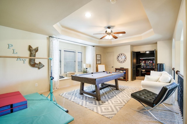 rec room with a raised ceiling, crown molding, light carpet, pool table, and ceiling fan