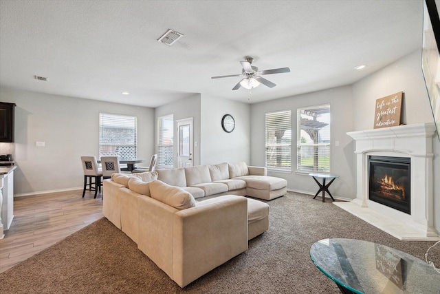 1127 Donnington Trl, Saginaw, TX 76131 - living room with a glass covered fireplace, a ceiling fan, baseboards, recessed lighting, and light wood-style floors