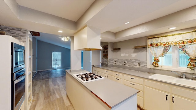 2810 Dove Meadow Dr, Garland, TX 75043 - kitchen featuring a sink, appliances with stainless steel finishes, backsplash, light wood-style flooring, and light countertops