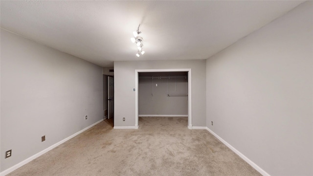 2810 Dove Meadow Dr, Garland, TX 75043 - unfurnished bedroom featuring light colored carpet, baseboards, a closet, and a walk in closet