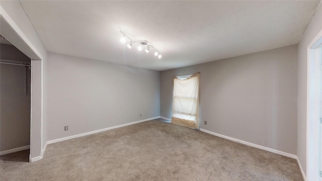 2810 Dove Meadow Dr, Garland, TX 75043 - carpeted empty room featuring a textured ceiling and baseboards