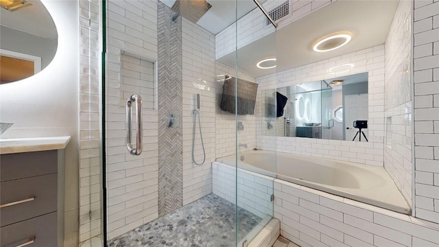 2810 Dove Meadow Dr, Garland, TX 75043 - full bathroom with a stall shower, vanity, tiled tub, and tile walls