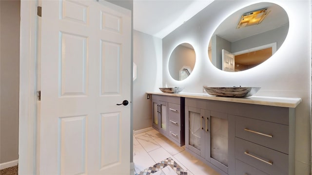 2810 Dove Meadow Dr, Garland, TX 75043 - full bathroom featuring baseboards, double vanity, and marble look tile flooring