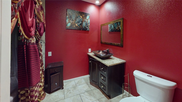 2810 Dove Meadow Dr, Garland, TX 75043 - bathroom featuring toilet, vanity, and a textured wall