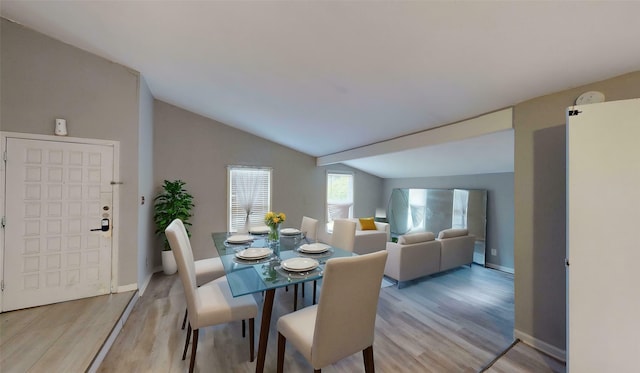 2810 Dove Meadow Dr, Garland, TX 75043 - dining space featuring vaulted ceiling, light wood-style floors, and baseboards