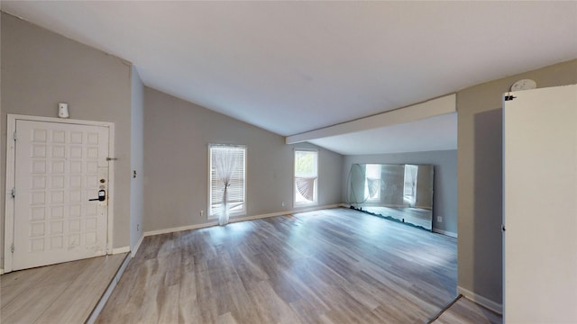 2810 Dove Meadow Dr, Garland, TX 75043 - unfurnished living room with vaulted ceiling, light wood-style flooring, and baseboards