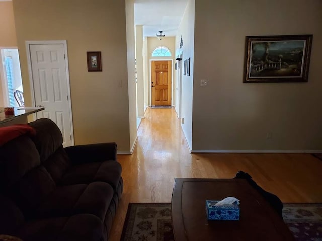 living area featuring light wood-style flooring and baseboards