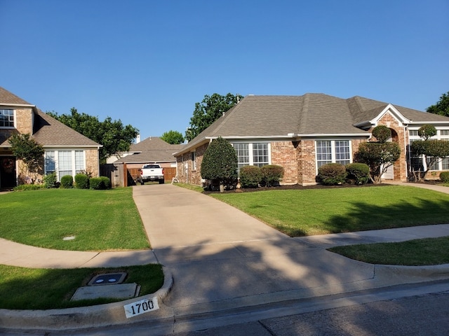 view of front of property featuring brick siding and concrete driveway