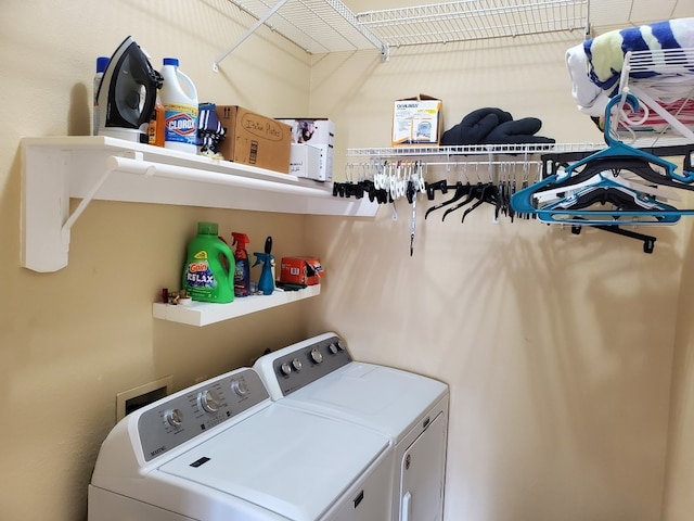 clothes washing area with washer and dryer