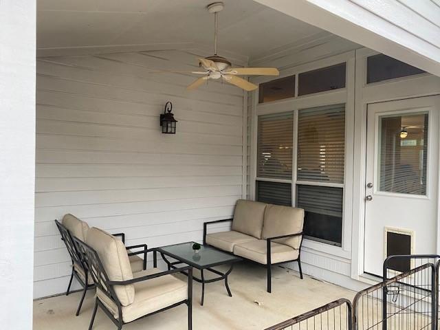 view of patio / terrace with ceiling fan and an outdoor living space