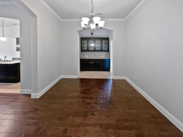 312 Canadian Ln, Burleson, TX 76028 - unfurnished dining area featuring a chandelier, wood finished floors, a sink, crown molding, and baseboards