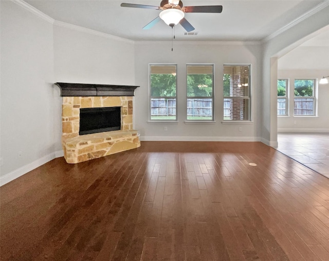 312 Canadian Ln, Burleson, TX 76028 - unfurnished living room with a ceiling fan, dark wood-type flooring, a stone fireplace, baseboards, and ornamental molding