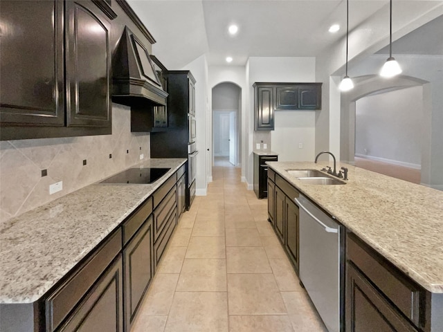 312 Canadian Ln, Burleson, TX 76028 - kitchen with arched walkways, a sink, stainless steel appliances, decorative backsplash, and premium range hood