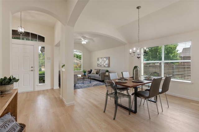 9716 Meadow Creek Dr, Denton, TX 76226 - dining room featuring arched walkways, lofted ceiling, light wood-type flooring, a chandelier, and baseboards