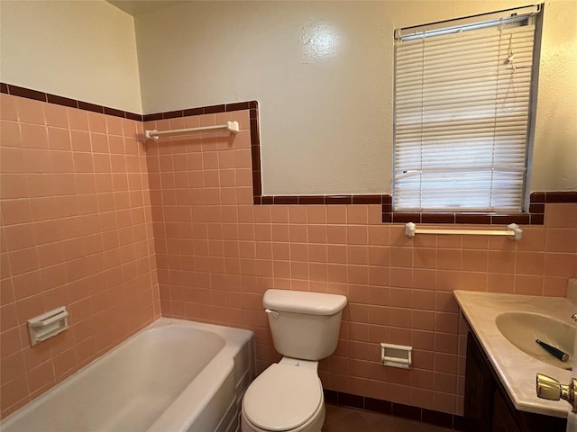 5004 Haywood Pkwy, Dallas, TX 75232 - full bathroom with tile walls, toilet, wainscoting, and vanity