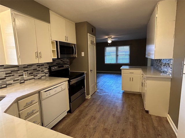 5004 Haywood Pkwy, Dallas, TX 75232 - kitchen with appliances with stainless steel finishes, white cabinets, dark wood-type flooring, backsplash, and a ceiling fan