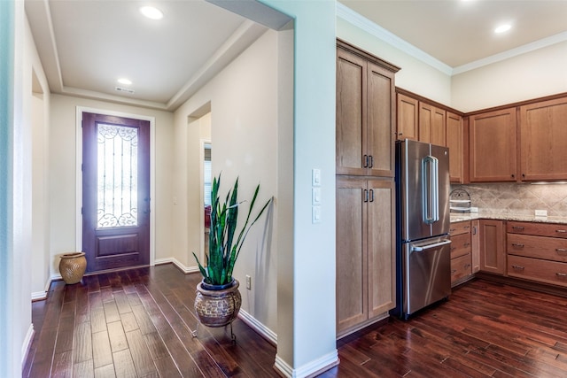 11708 Southerland Dr, Denton, TX 76207 - kitchen with freestanding refrigerator, dark wood finished floors, backsplash, baseboards, and ornamental molding