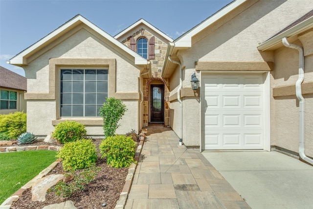 11708 Southerland Dr, Denton, TX 76207 - view of front of house featuring stucco siding, concrete driveway, stone siding, and a garage