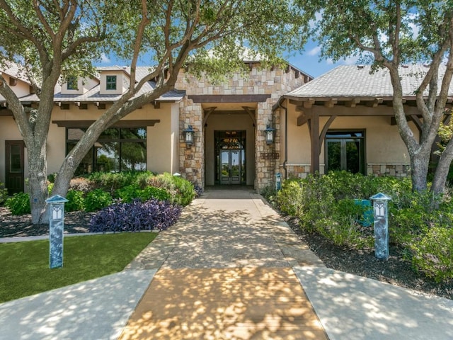 11708 Southerland Dr, Denton, TX 76207 - doorway to property with french doors, stone siding, and stucco siding
