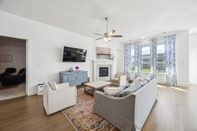 1908 St Andrews Dr, Celina, TX 75009 - living area featuring wood finished floors, ceiling fan, a glass covered fireplace, and baseboards