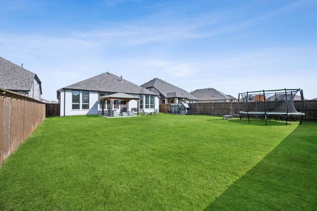 1908 St Andrews Dr, Celina, TX 75009 - rear view of house with a trampoline, a patio, and a gazebo