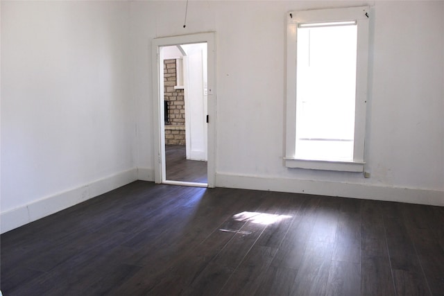 534 N Race St, Stephenville, TX 76401 - spare room with baseboards and dark wood-style flooring