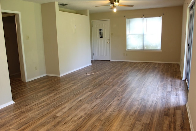 534 N Race St, Stephenville, TX 76401 - unfurnished room with ceiling fan, dark wood-type flooring, and baseboards