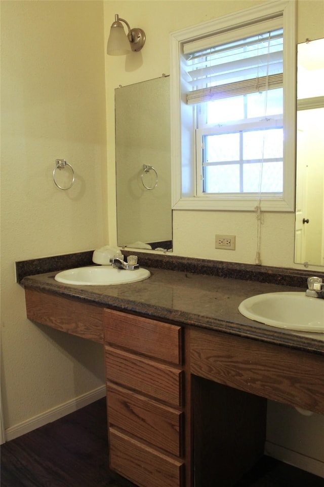 534 N Race St, Stephenville, TX 76401 - full bathroom featuring wood finished floors, double vanity, and baseboards