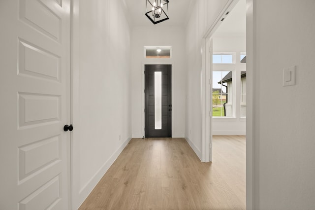 4413 Sandstrom Way, Fort Worth, TX 76179 - foyer featuring baseboards, light wood finished floors, and a chandelier