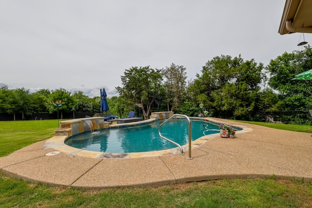 swimming pool featuring a lawn, a patio area, and a water slide