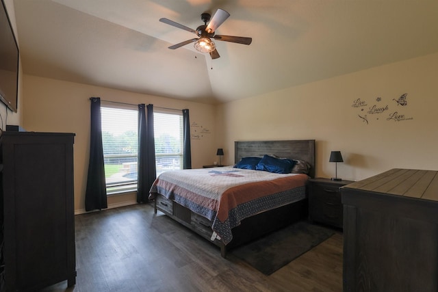 bedroom featuring vaulted ceiling, dark wood-style flooring, ceiling fan, and baseboards