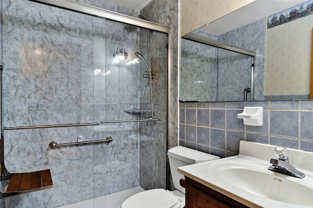 full bath with a shower stall, toilet, vanity, and tile walls
