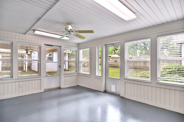 unfurnished sunroom featuring ceiling fan and healthy amount of natural light