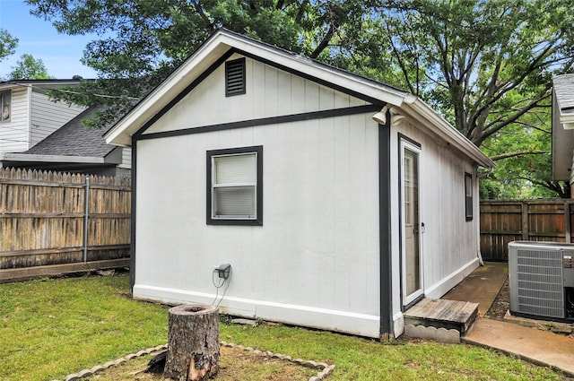 view of property exterior featuring central AC and an outbuilding