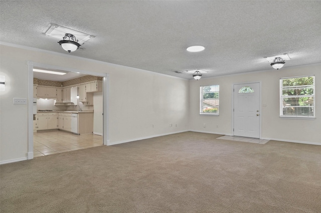 unfurnished living room with light carpet, a textured ceiling, baseboards, and light tile patterned flooring