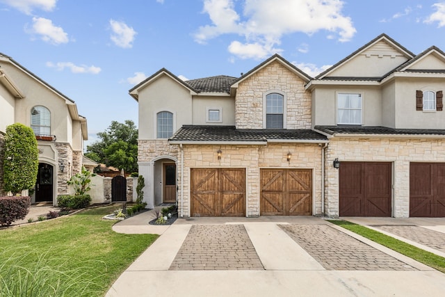 2576 Fountain Cv, Carrollton, TX 75006 - view of front of house featuring stone siding, stucco siding, an attached garage, and driveway
