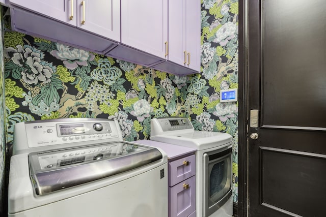 2576 Fountain Cv, Carrollton, TX 75006 - laundry area with cabinet space, washing machine and clothes dryer, and wallpapered walls