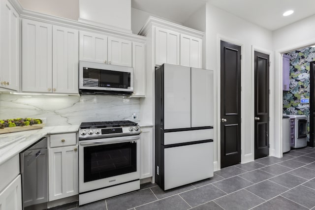 2576 Fountain Cv, Carrollton, TX 75006 - kitchen featuring stainless steel appliances, dark tile patterned flooring, white cabinets, tasteful backsplash, and recessed lighting